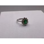 A certified 18ct white gold oval emerald and diamo