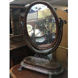 A Victorian mahogany dressing mirror with an oval on scroll supports. Height 90cm No Reserve.