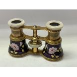A pair of French enamelled opera glasses with mother of Pearl fittings. ( some unfortunate damage).