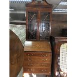 A well proportioned quality Edwardian bureau bookcase with a shaped pediment above a fall front