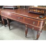 A George III Mahogany sideboard with a cross-banded top above three drawers on turned and fluted