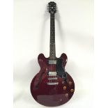An Epiphone Dot electric guitar in burgundy. Comes
