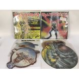 A collection of Iron Maiden picture discs, some si