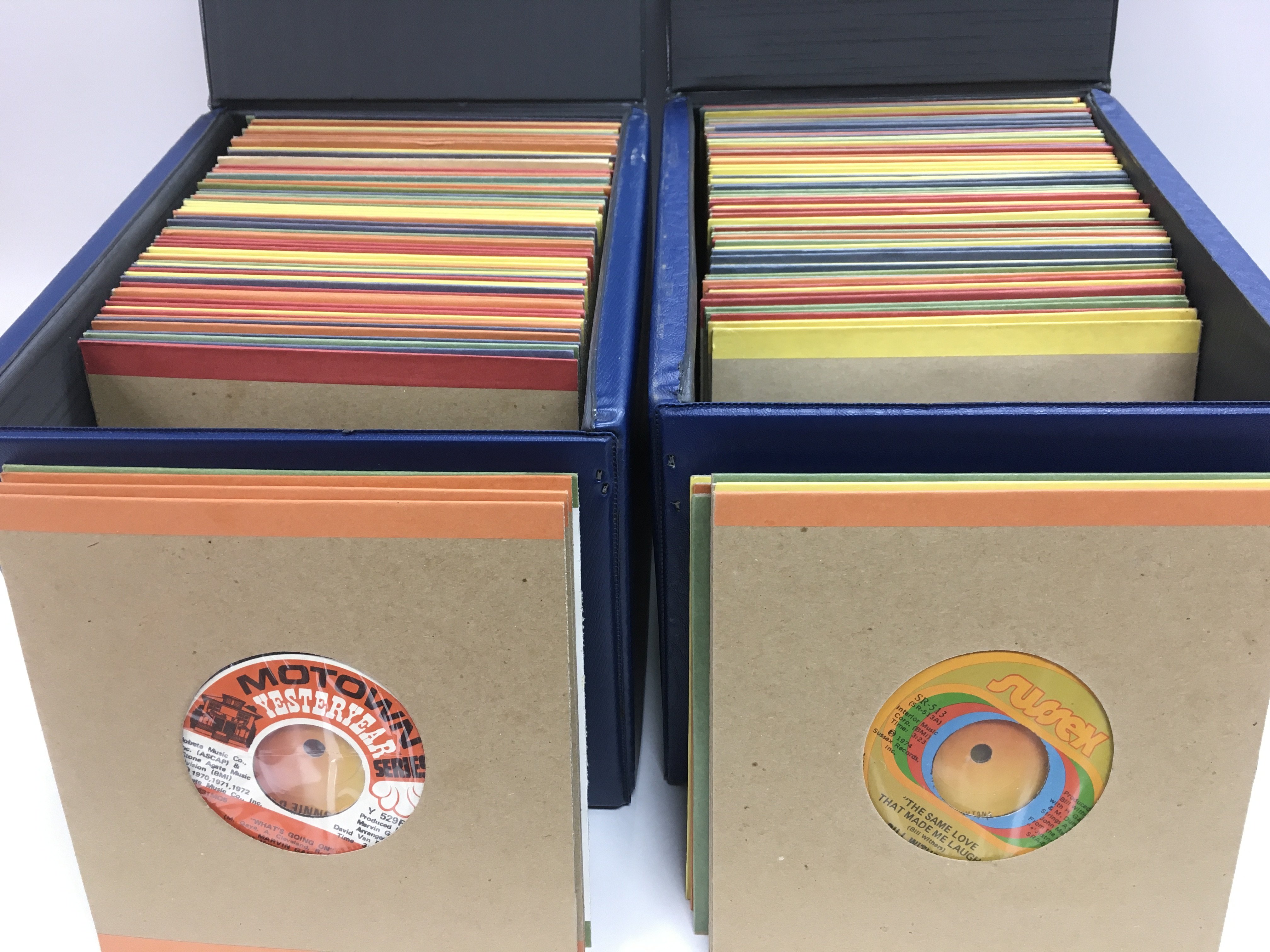 Four record cases of 7inch singles by various rock