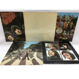 Five Beatles LPs including a numbered top loading