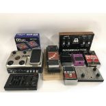 A collection of guitar effects pedals and accessor