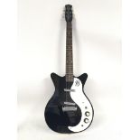 A Danelectro electric guitar in black and white. N