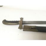 A sword with with a brass cross guard slightly cur