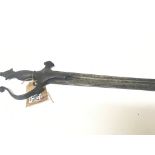 A Middle Eastern sword with a metal grip curved bl