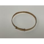 A 9ct gold adjustable baby bangle. Approx 3.5g.