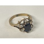 A Sapphire cluster ring set in Gold, size Q.