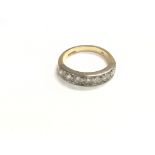 An 18ct gold and platinum ring set with a row of s