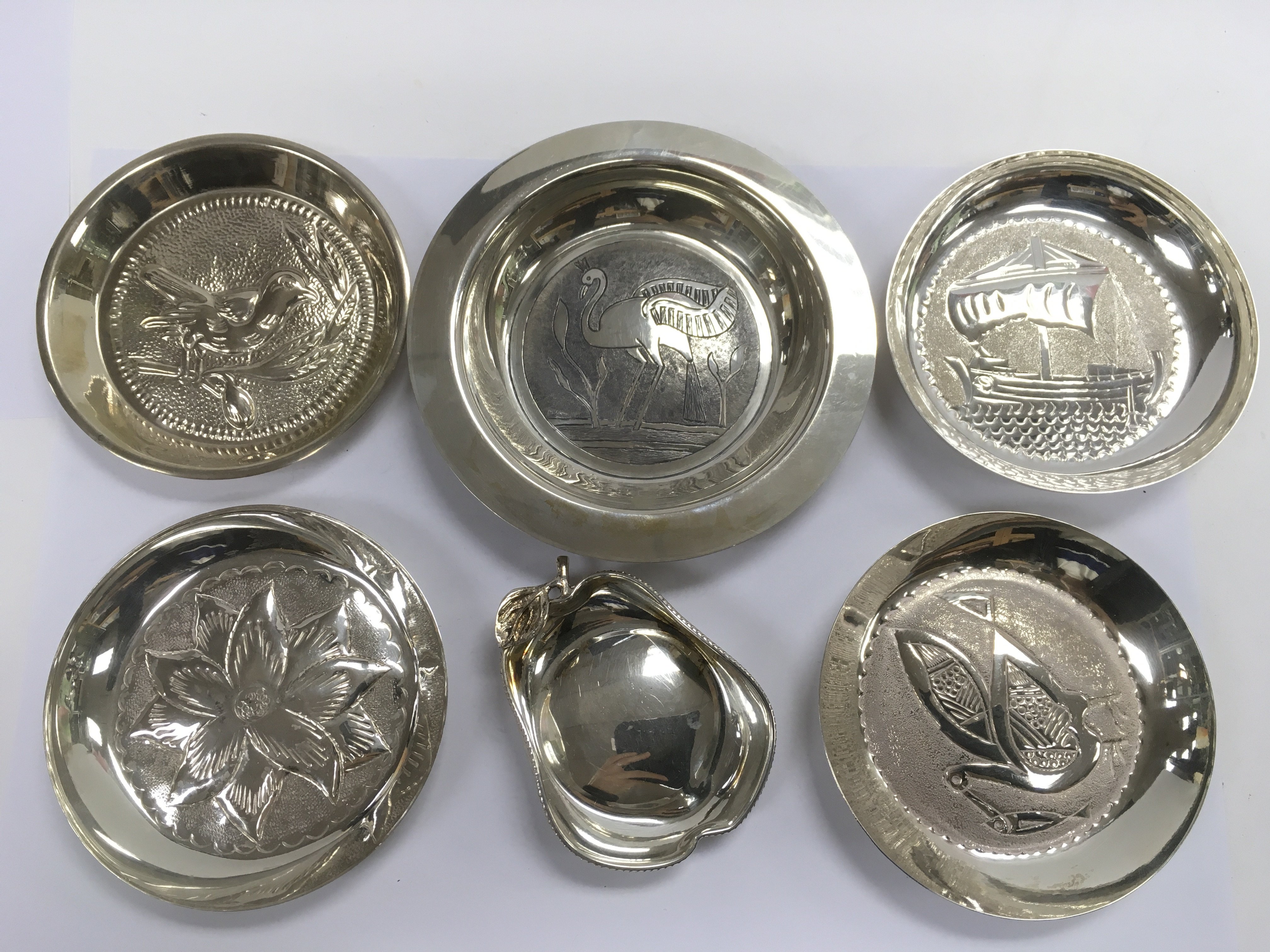 Six silver dishes, various designs, largest diamet