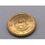 A gold Krugerrand 1972 weight 33.95 approximately.