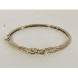 A multi Diamond set bangle in 9ct Gold