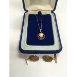 A 9ct gold pendant set with a single pearl and sus