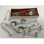 A group of silver items comprising spoons, sugar n