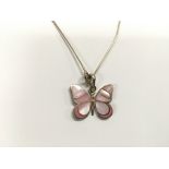 A silver and enamel butterfly pendant.