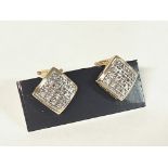 A pair of Diamond set earrings with continental fi