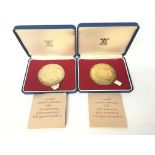 Two medals struck in celebration of the 25th anniv