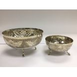 Two silver bowls decorated with leaves and fruit,