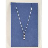 A Triple drop Dimond pendant and chain in White Go