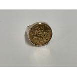 A 9ct gold ring inset with a 1908 half sovereign. Approx 10.4g