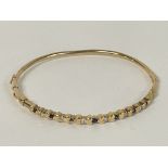 A Sapphire and Diamond set bangle in 9ct Gold