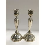 A pair of silver candlesticks, London hallmarks, a
