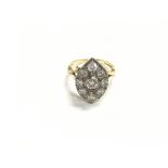 An 18ct gold diamond cluster ring with central sto