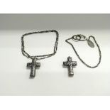 Two silver cross pandants and chains.