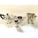 Silver plated tea set and four goblets.