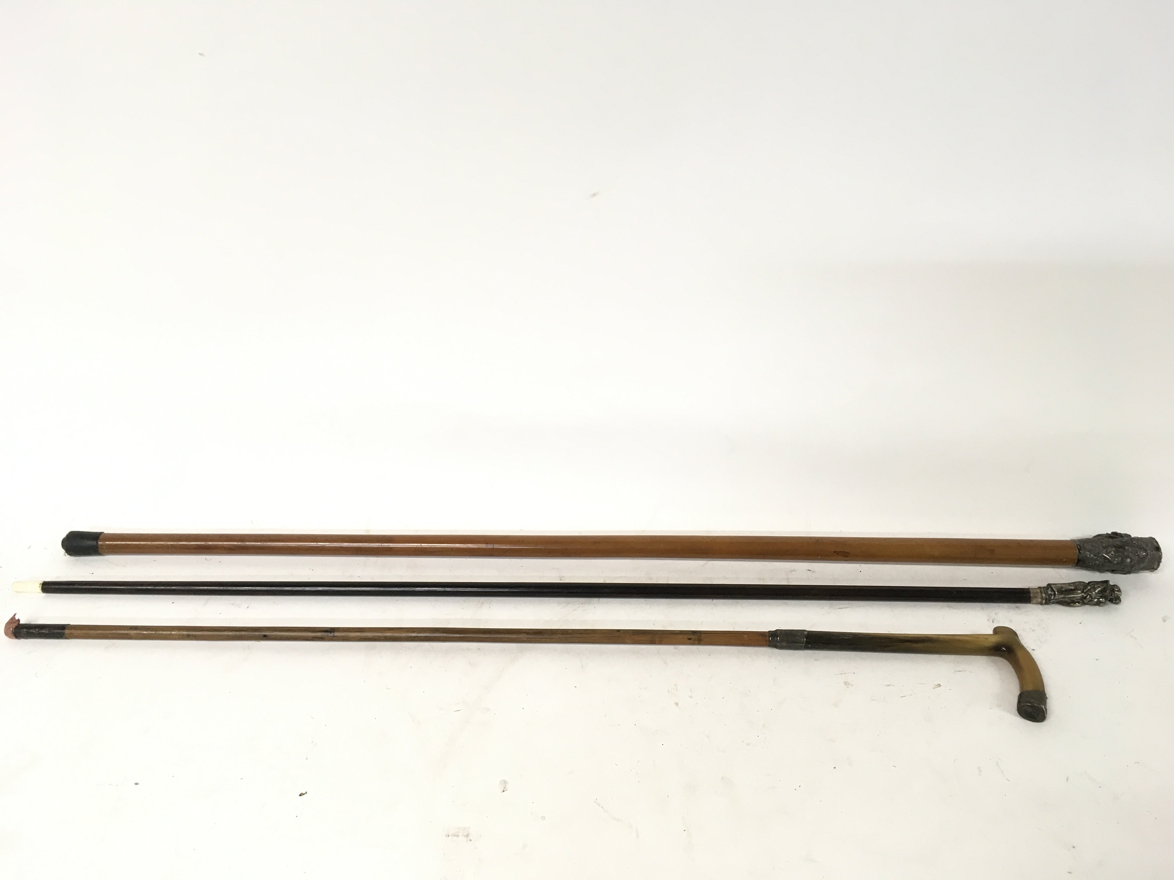 Walking sticks- Ebonized stick topped with monk an