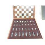 A teak and rosewood Camelot chess board with pewte