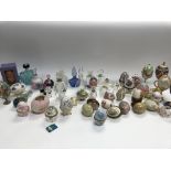 A large collection of decorative eggs and perfume