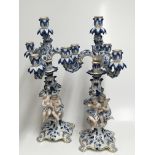 A pair of Meissen candelabra with blue, white and