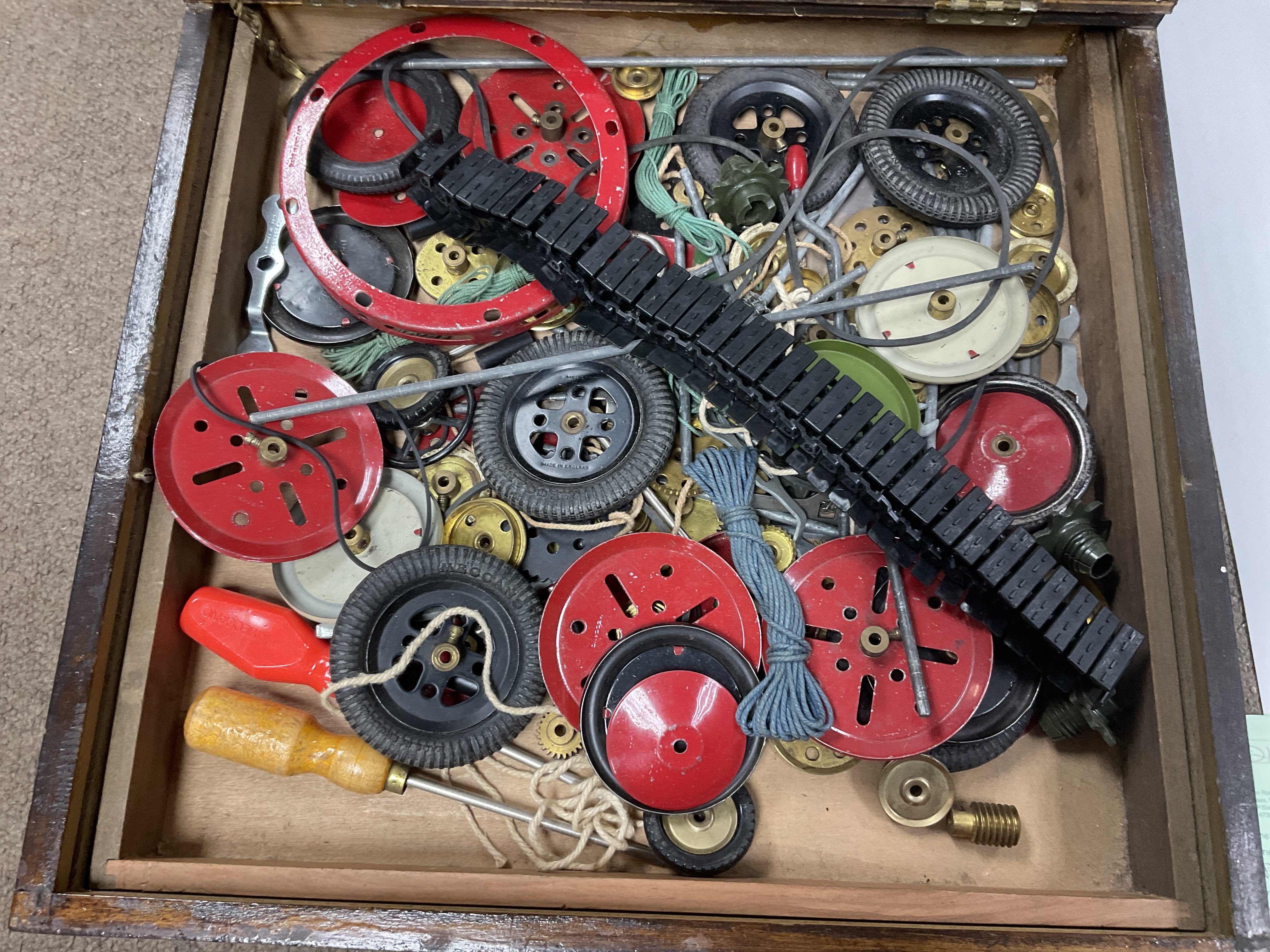 A box of mixed Meccano parts.