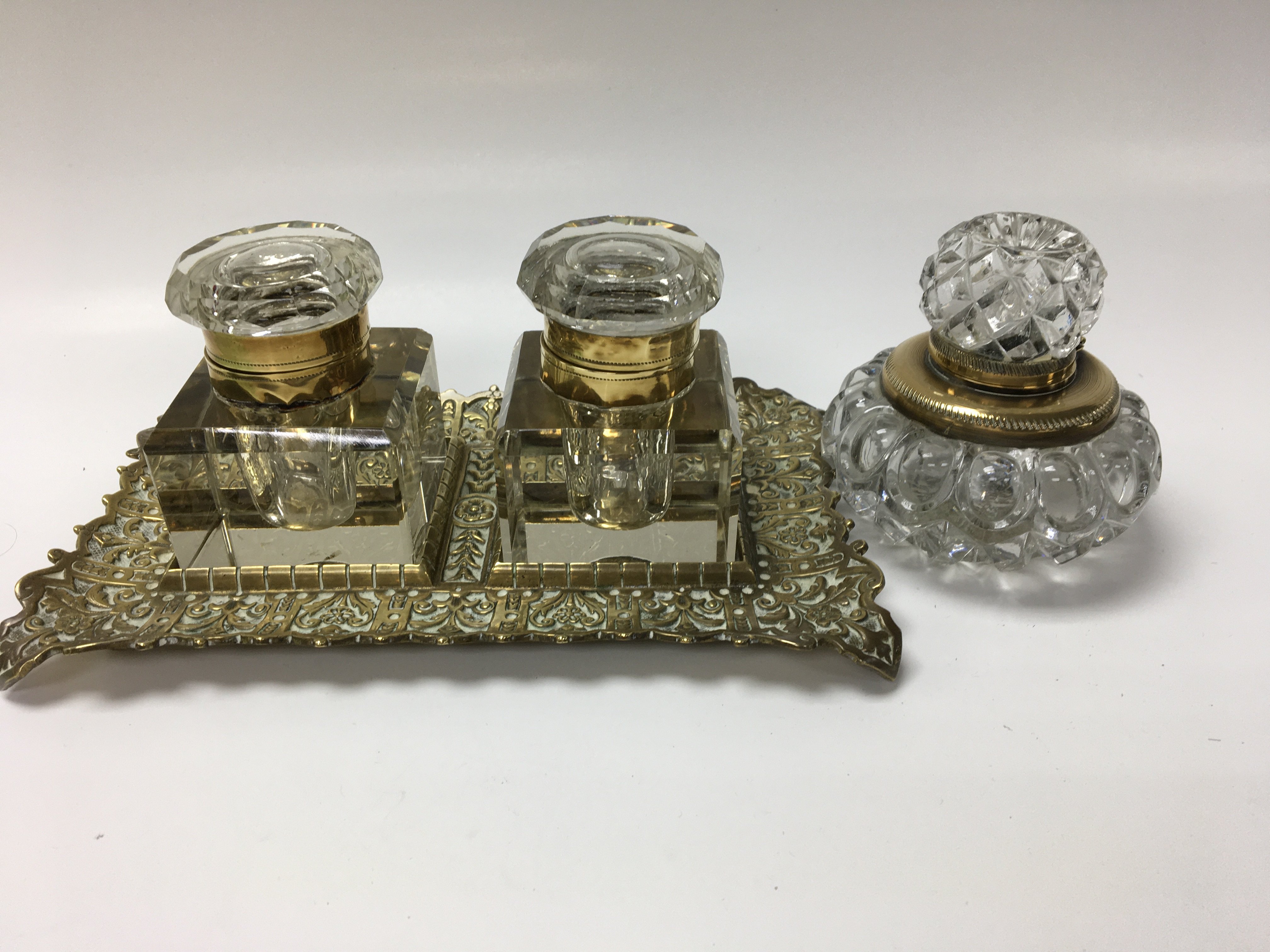 A pair of inkwells on brass stand and a single ink