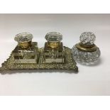 A pair of inkwells on brass stand and a single ink