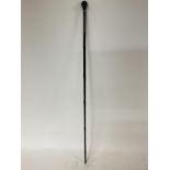 Ebonized walking cane presenting a Native Africans