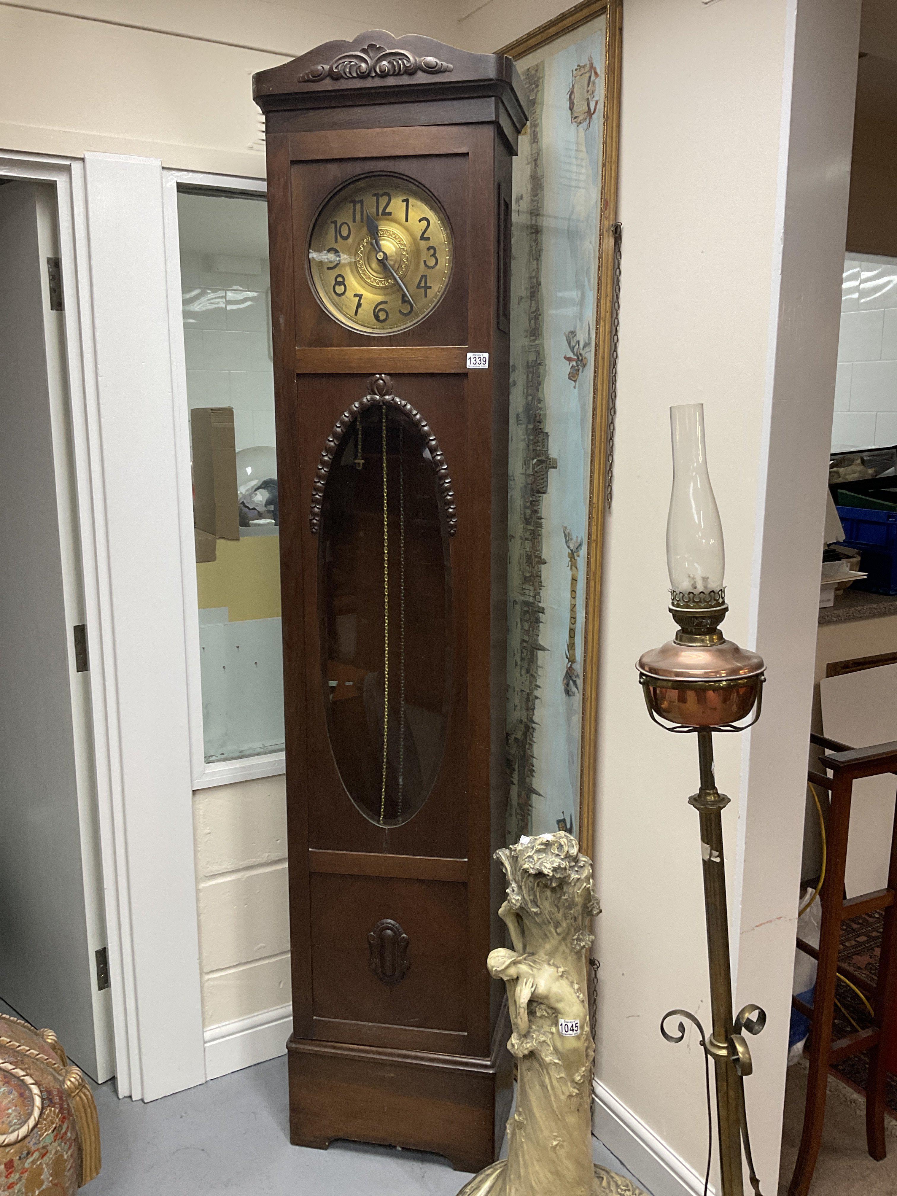 A 1930s oak cased grandfather clock.