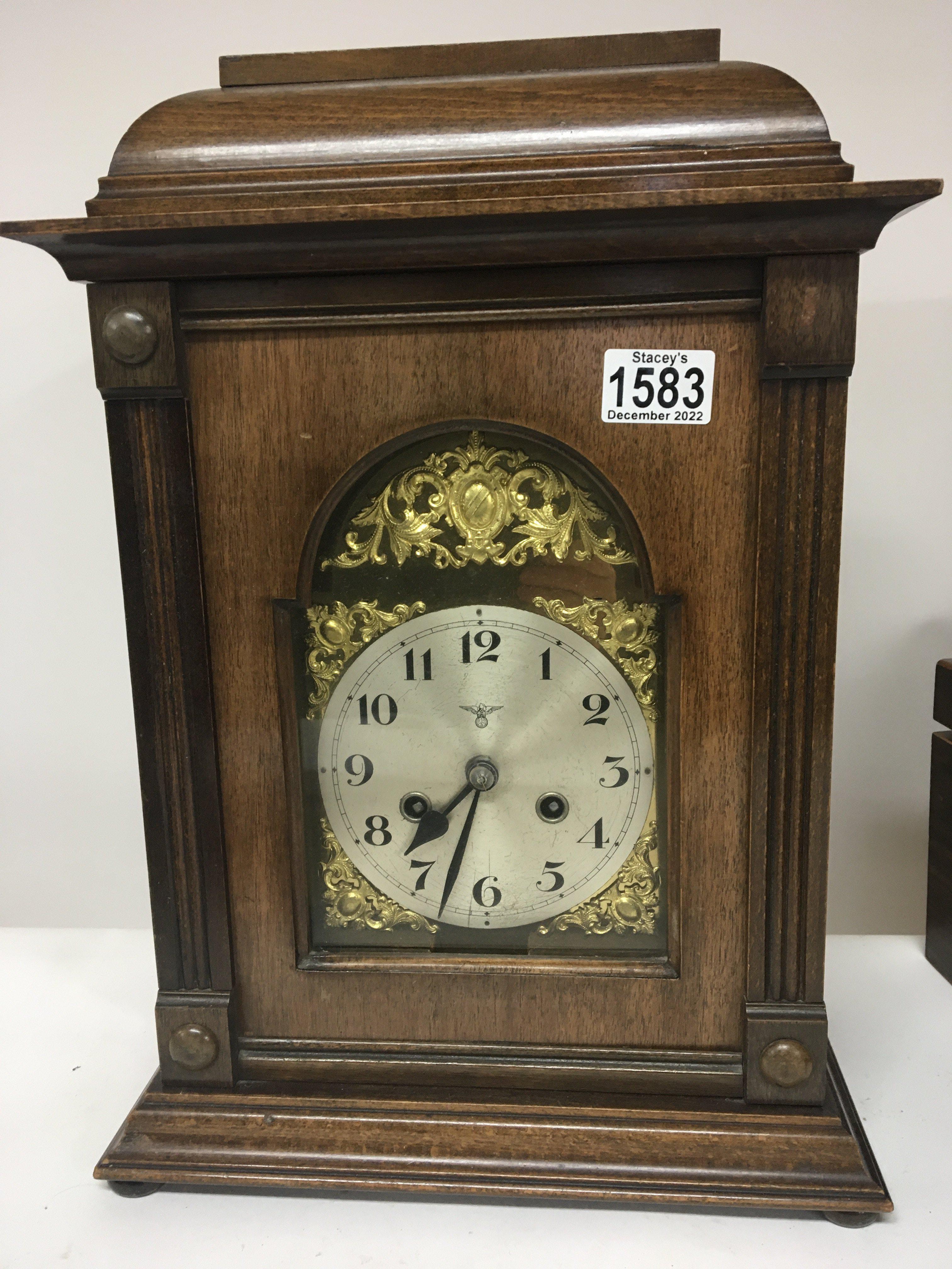 A Continental cased mantel clock with a silvered d
