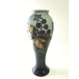 A Moorcroft vase decorated with Berries and leaves