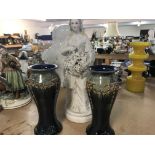 A pair of Doulton vases and a bisque figure.