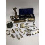 A collection of silver and white metal items inclu
