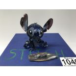 A Disney Swarovski Crystal figure of Stitch complete with box and name bar. ( 1 finger missing).