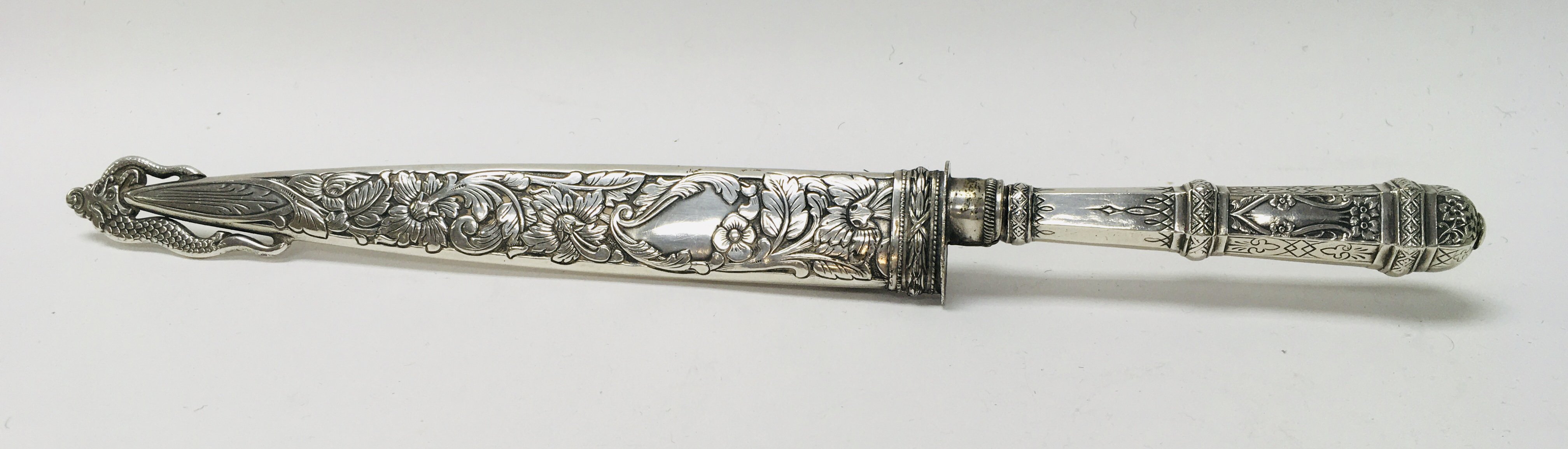 An Ornate silver plated dagger with Inox blade and