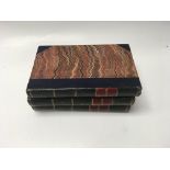 A collection of Scott's leather + board bound book