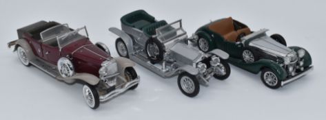 Three Franklin Mint diecast model vehicles comprising The 1930 Duesenberg J Derham Tourster, The