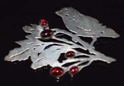 A silver brooch in the form of a bird set with garnet cabochons, maker's mark to verso, 7.5 x 5cm